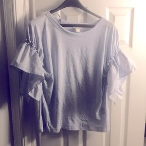 Light blue ruffled top.